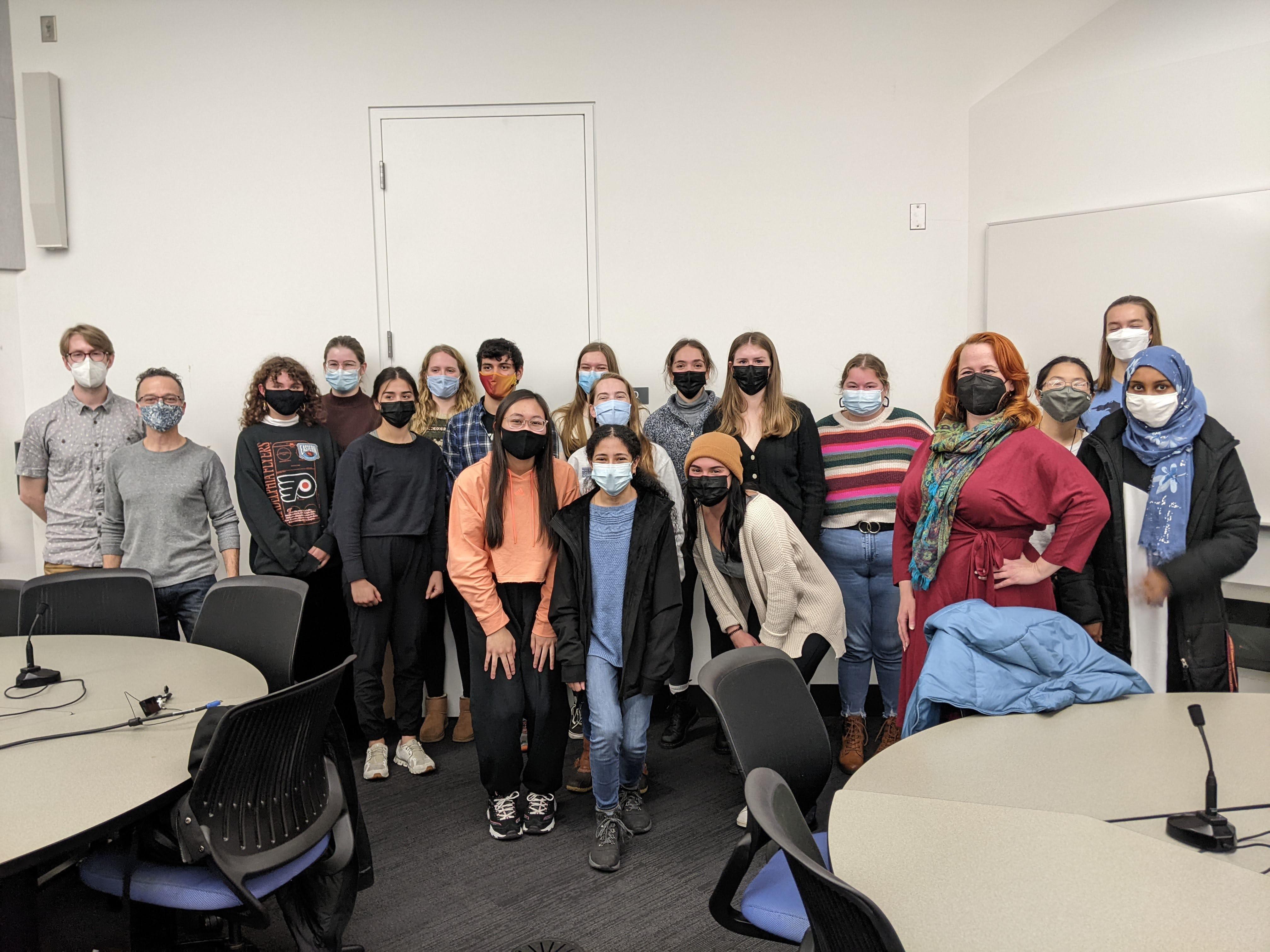 Photo of students standing in a classroom with masks on.